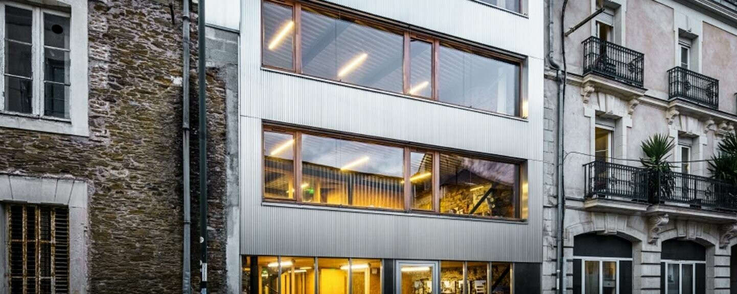 Vue de face de l'immeuble de bureaux à Nantes, revêtu du profilé crénelé PREFA dans la couleur aluminium naturel.