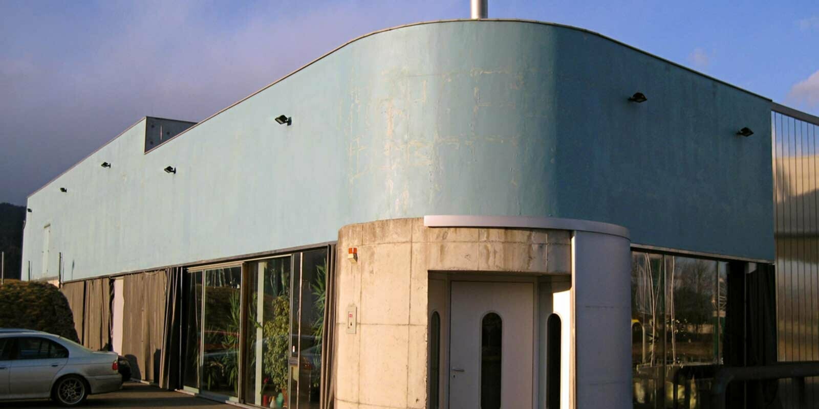 Edificio prima della ristrutturazione della facciata arrotondata con losanghe PREFA