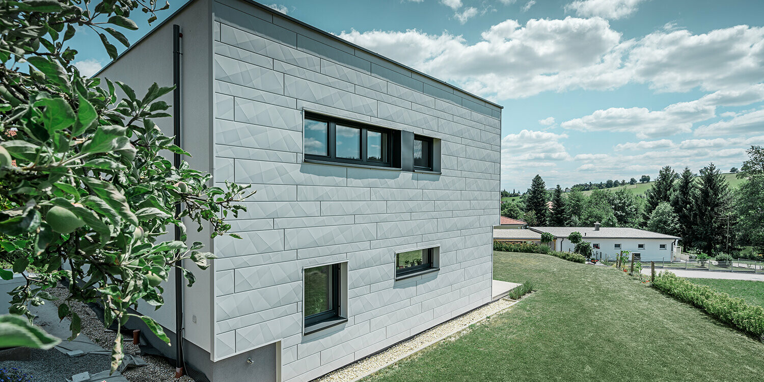 Vue latérale d’une maison individuelle moderne, avec façade en Siding.X visible.