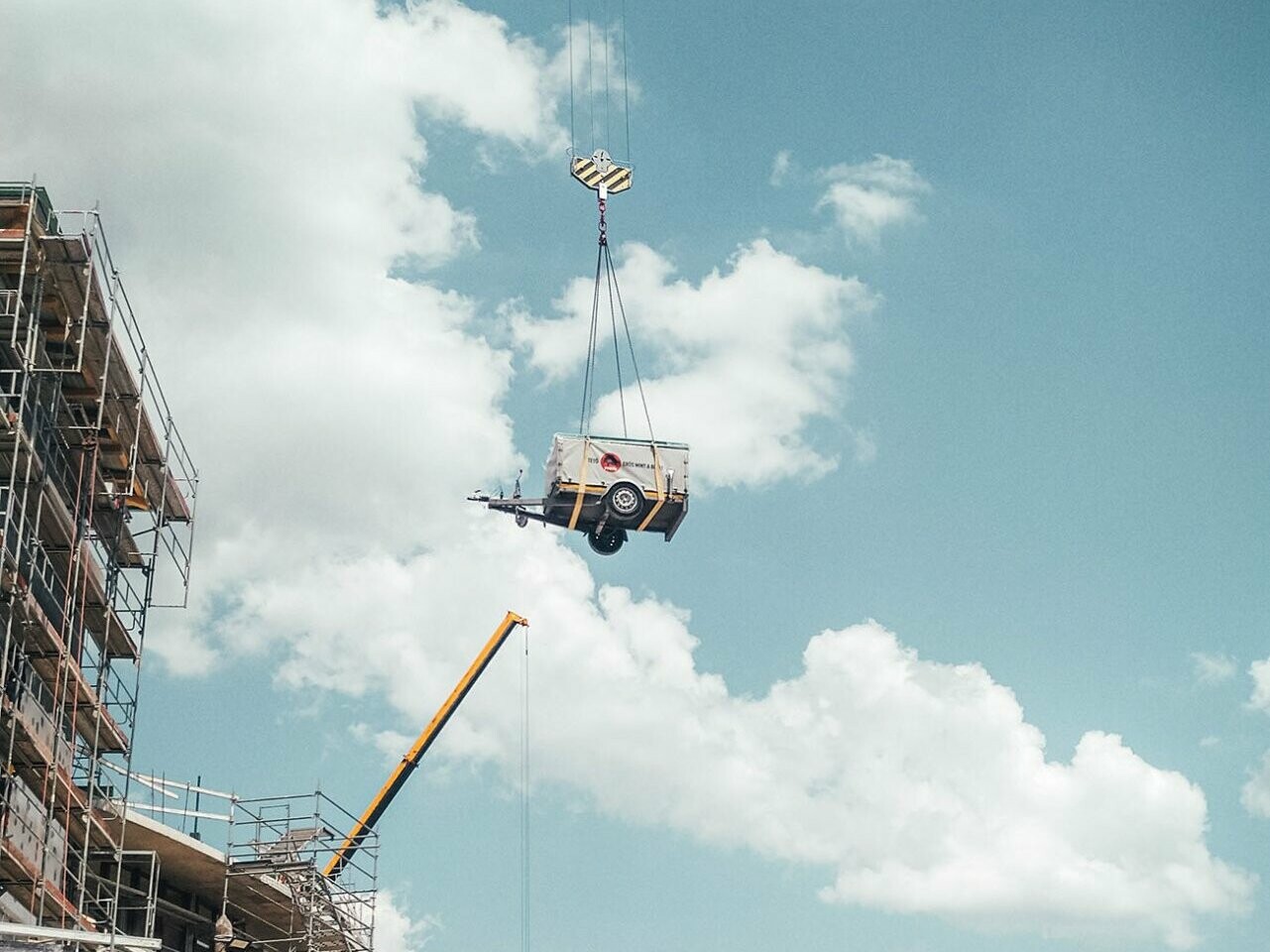 Faltbare Maschine, die über die Baustelle gehoben wird