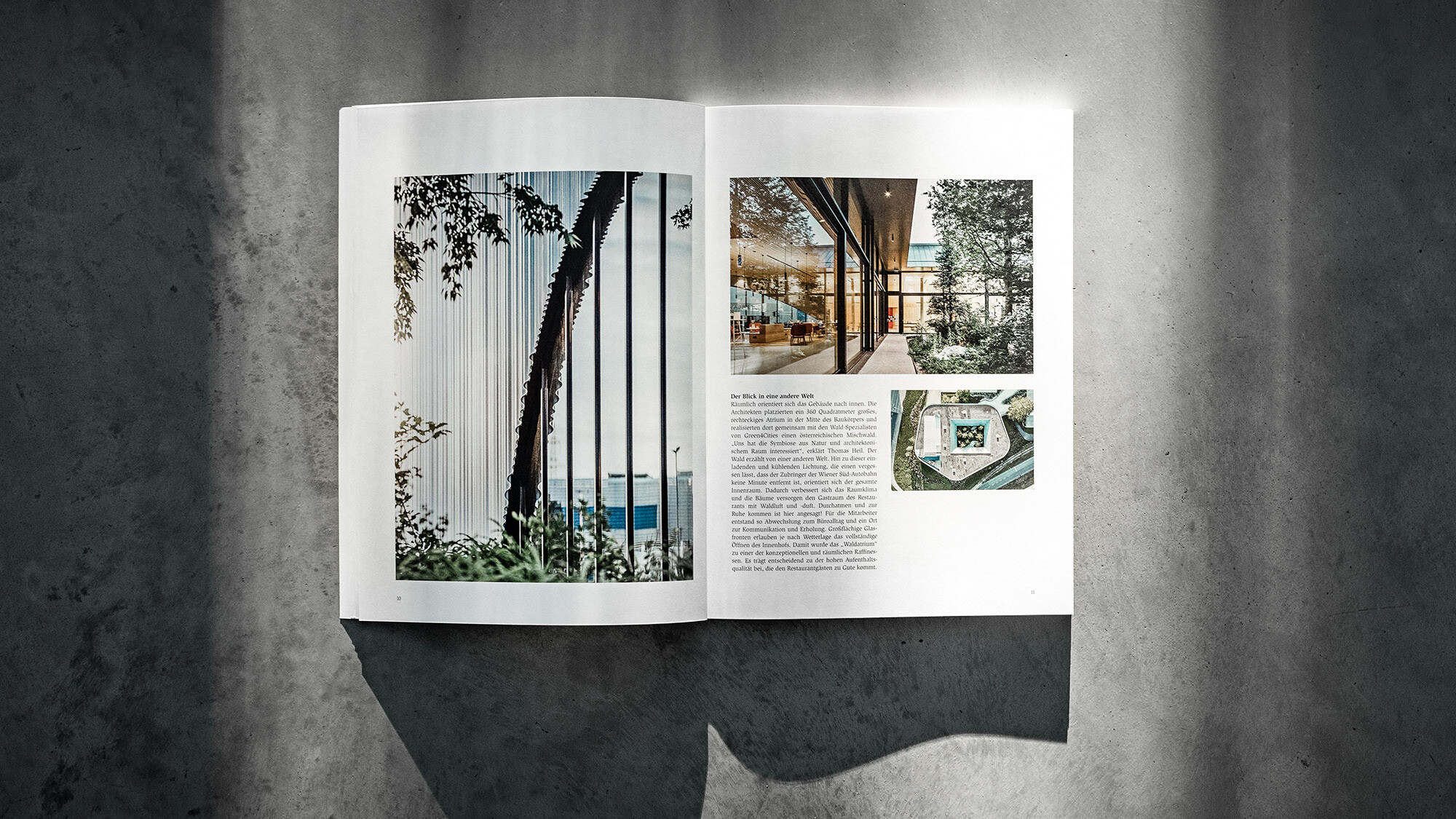 Libro PREFARENZEN 2024 aperto, su sfondo grigio, con un articolo sul progetto del ristorante Walter, opera dello studio dreiplus Architekten.