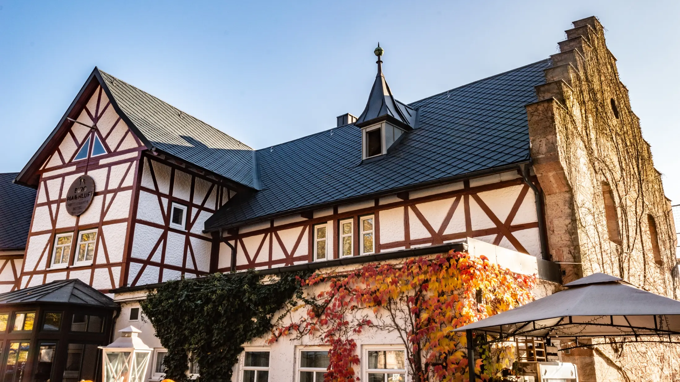 L’hôtel Burg Maienluft a été recouvert de losanges de toiture 29 × 29 PREFA couleur anthracite, la façade est à colombage.