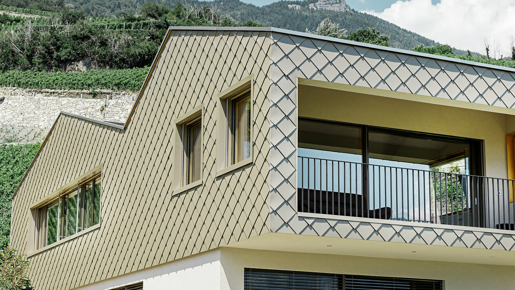 Maison individuelle dans les vignes, revêtue de losanges de toiture PREFA couleur bronze
