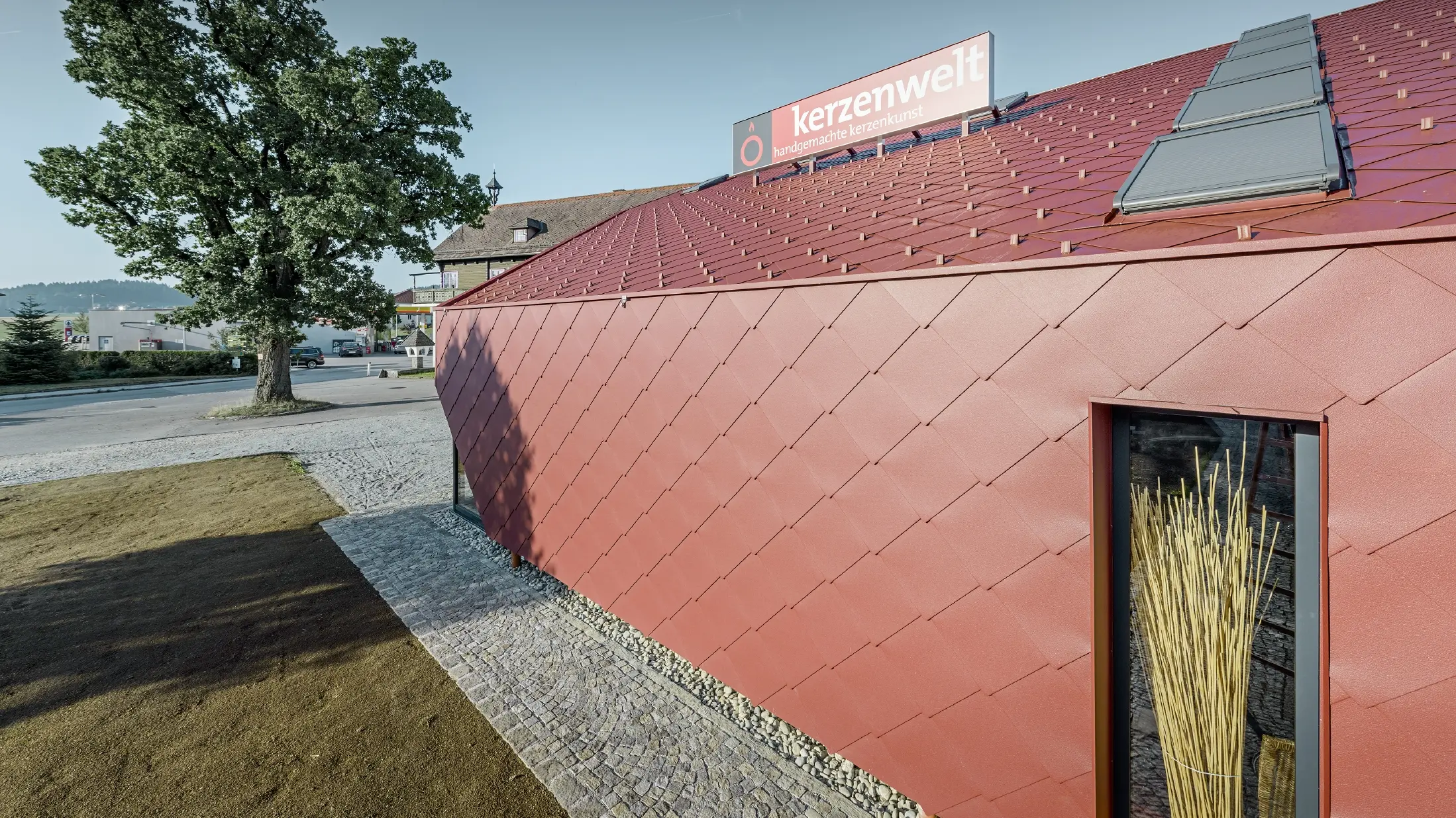 Le Kerzenwelt de Schlägl a été entièrement habillé de losanges PREFA. La couverture de toit et l’habillage de façade ont été réalisés avec le losange 44 × 44 couleur rouge oxyde.