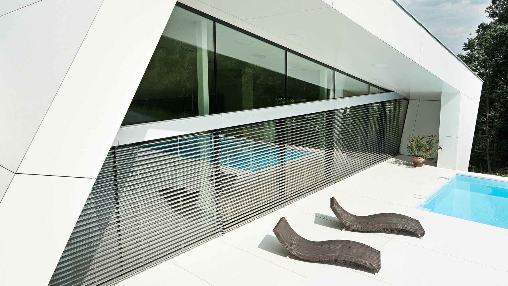 Casa unifamiliare moderna con piscina. La facciata dell’edificio è stata rivestita con pannelli compositi nel colore bianco puro.